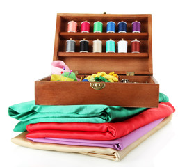 Naklejka premium Sewing kit in wooden box and cloth isolated on white