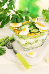 Delicious salad with eggs, cabbage and cucumbers on wooden