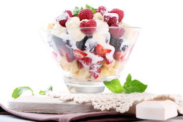 Fruit salad in glass bowl, isolated on white