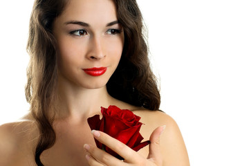 Obraz na płótnie Canvas Young beautiful woman holding red rose