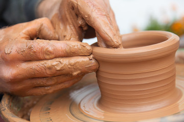 craftsman works in clay dishes