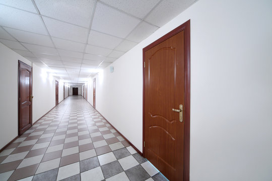 Long bright hallway with wooden doors