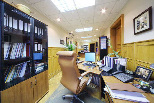 Light office with desktop, computer, leather armchair