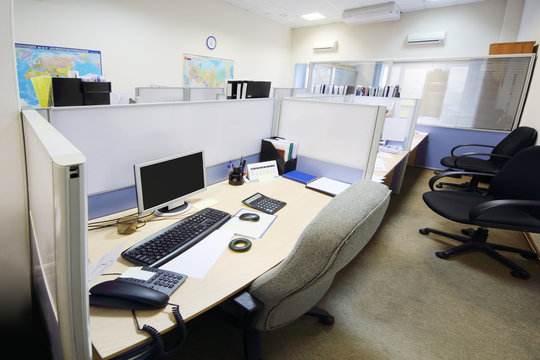 Empty official place separated by partition with desk, armchair