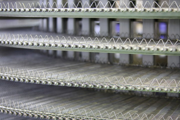 Grill and conveyor for frying meatballs and other meat products.