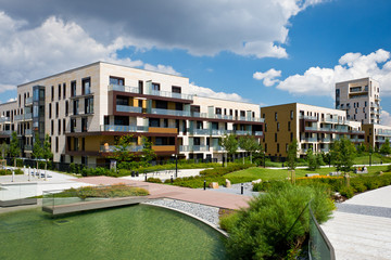 View of public park with newly built modern block of flats
