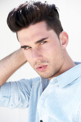 Attractive male fashion model with hand in hair