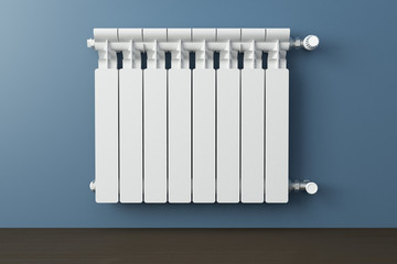 Heating radiator in a room with laminated wooden floor - obrazy, fototapety, plakaty