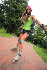 Fototapeta premium woman roller skating sport activity in park