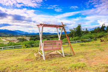 blue sky with  wooden swing in the garden