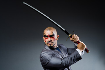 Man with face paint and sword © Elnur
