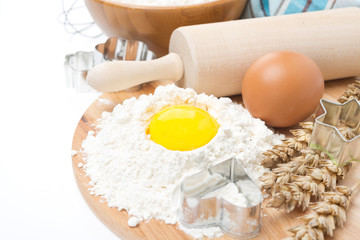 baking ingredients - flour, eggs, rolling pin and baking forms