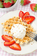 Belgian waffles with fresh strawberries and whipped cream