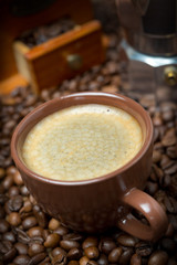 cup of black coffee on background coffee beans, selective focus