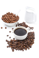 cup of black coffee, chocolate flakes and milk isolated on white