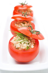 Fresh tomatoes stuffed with tuna salad and bulgur, vertical