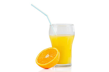 Glass of fresh orange juice with straw and orange half