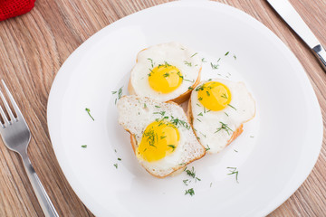 Fried quail eggs on baguette
