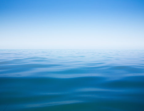 clear sky and calm sea or ocean water surface background