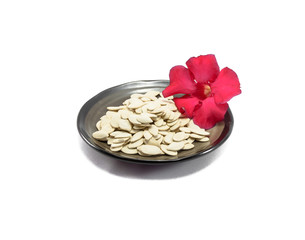 white pumpkin seed on dish and flower isolated