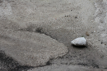 Fototapeta na wymiar Gray rocks on the sand