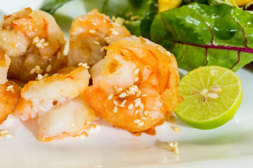 Fresh salad with fried shrimps, variety of salad leafs, mango, a