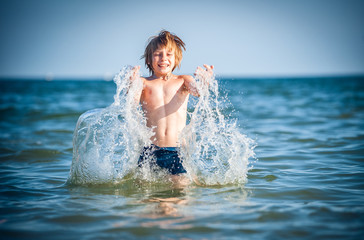 happy little boy in the sea