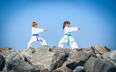 Children training karate on the stone coast