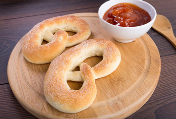 Soft pretzels, apricot jam and glass of milk