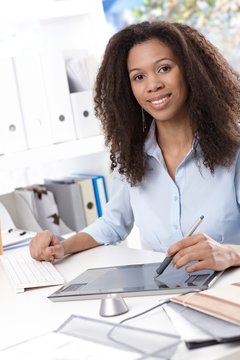 Smiling businesswoman with drawing pad