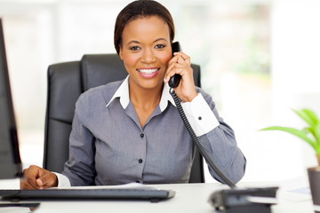 african american businesswoman using landline phone