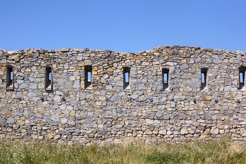 Ancient broken wall with little windows