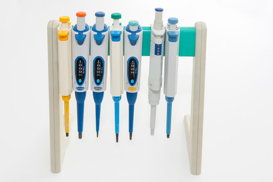 Colorful medical pipettes on white background