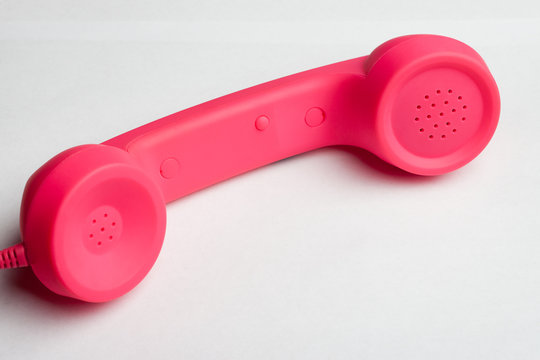 Pink phone on white surface