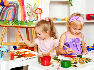 Child painting at easel.