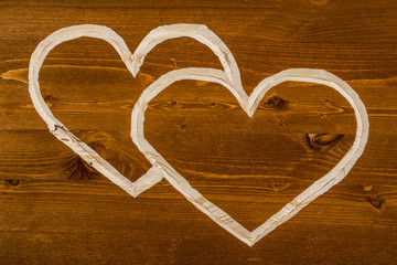 Сarved hearts on orange wood background