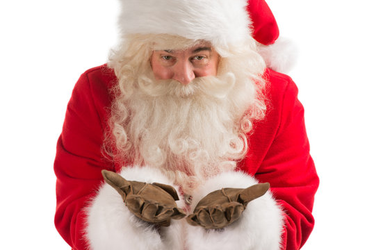 Portrait of Santa Claus blowing and looking at camera