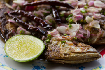Close-up of fried salted mackerel topped with chili
