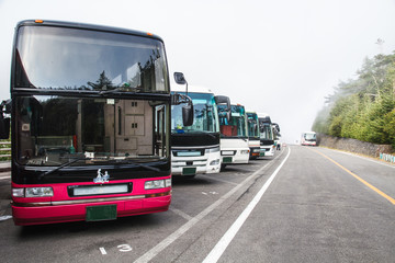 Many bus coach are lined up at the parking lot of Mount Fuji. © Masato