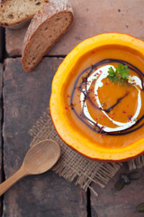 Colourful autumn pumpkin soup in the gourd