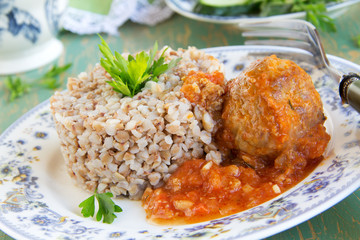 buckwheat in a wooden plate with chicken.