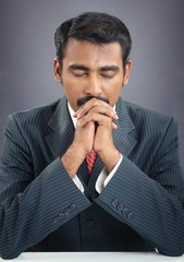 indian young businessman praying