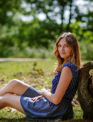 Fototapeta premium Portrait of young beautiful woman relaxing in summer forest