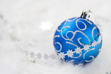 Blue christmas ball and snowflake lace on white feathers