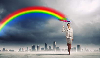 Young business woman holding an umbrella