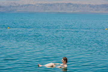 one woman swimming bathing in dead sea jordan