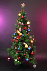 Decorated Christmas tree on dark color background