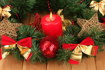 Fototapeta na wymiar Christmas composition with candle and decorations in red and