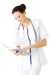 Fototapeta premium Attractive medicine student or doctor with book