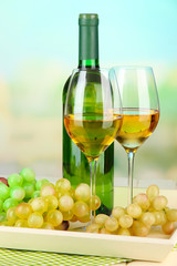 Fototapeta na wymiar Ripe grapes, bottle and glasses of wine
